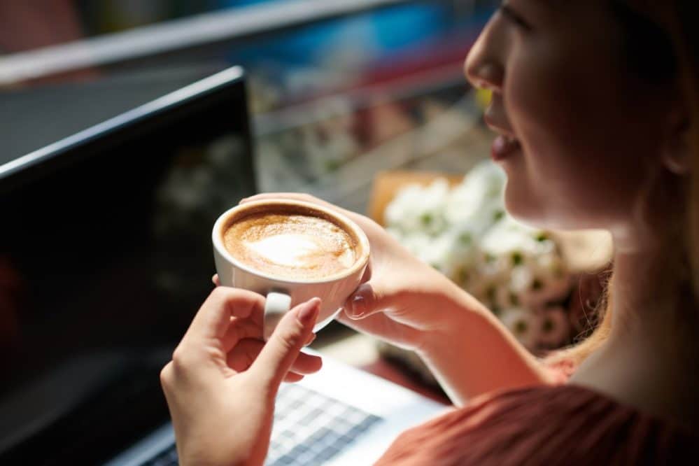 woman drinking coffee in coffeeshop