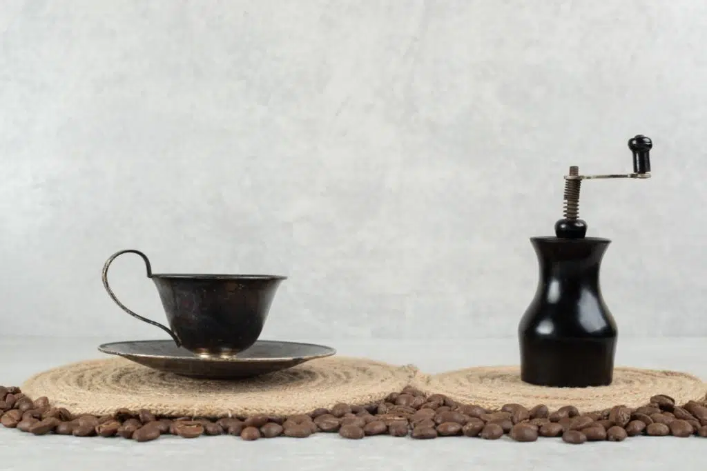 coffee beans and coffee grinder on marble background